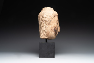 A Thai sandstone head of Buddha, possibly Ayutthaya period, 14/15th C.