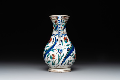 A polychrome and gilt Iznik ewer with tulips, carnation flowers and saz leaves, Turkey, ca. 1600