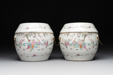 A pair of Chinese famille rose jars and covers with figures in a garden, Tongzhi mark and of the period