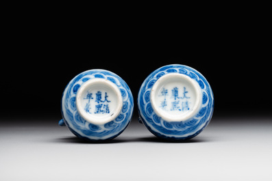 A pair of Chinese blue and white miniature 'hu' vases on wooden stands, Kangxi mark, 19th C.