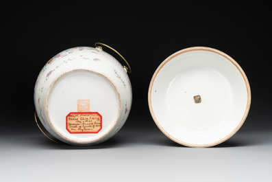 A pair of Chinese famille rose jars and covers with figures in a garden, Tongzhi mark and of the period