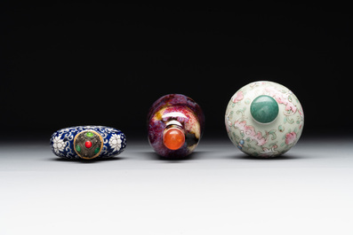 Two Chinese famille rose 'lotus scroll' snuff bottles and a flamb&eacute;-glazed snuff bottle, 19th C.