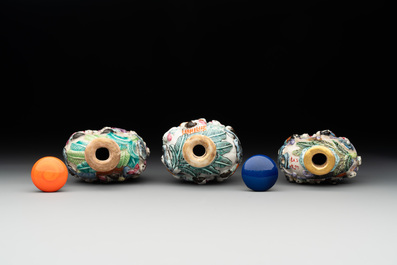 Six Chinese moulded famille rose snuff bottles, Qianlong mark, 19th C.