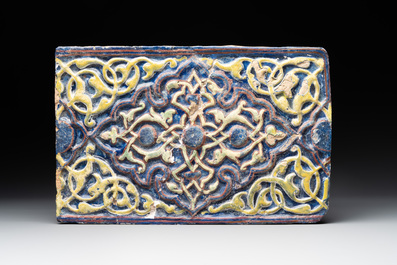 An Kashan lustre-glazed star tile and a rectangular moulded ornamental tile, Persia, 13/14th C.