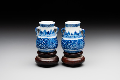 A pair of Chinese blue and white miniature 'hu' vases on wooden stands, Kangxi mark, 19th C.