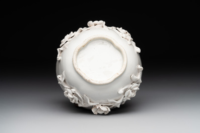 A Chinese blue and white 'butterfly' cup and saucer with applied floral design, Qianlong