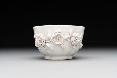 A Chinese blue and white 'butterfly' cup and saucer with applied floral design, Qianlong