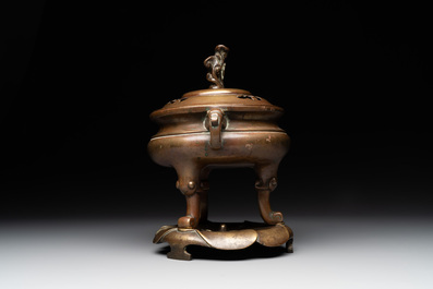 A Chinese bronze tripod censer with cover and stand, 19th C.