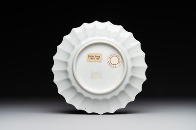 A Chinese famille rose cup and saucer with a reclined lady, Qianlong