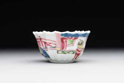 A Chinese famille rose cup and saucer with a reclined lady, Qianlong