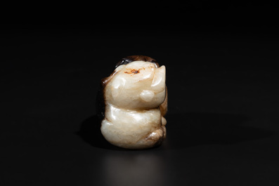 A Chinese celadon and russet jade mythical beast carving, Ming