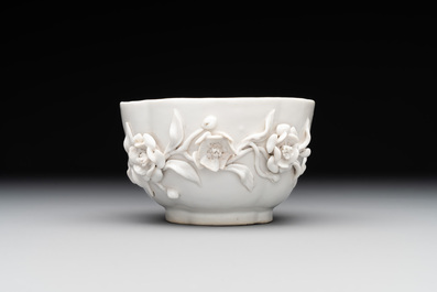 A Chinese blue and white 'butterfly' cup and saucer with applied floral design, Qianlong