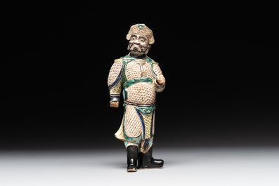 A fine Chinese verte biscuit figure of a warrior on wooden stand, Kangxi