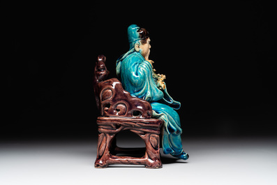 A Chinese turquoise- and aubergine-glazed sculpture of a seated scholar, 18/19th C.