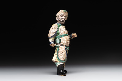 A fine Chinese verte biscuit figure of a warrior on wooden stand, Kangxi