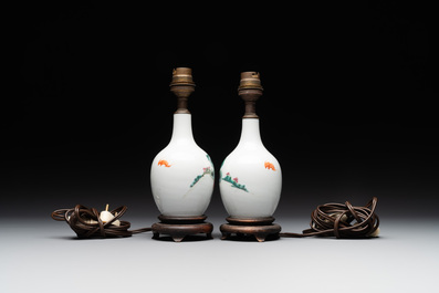 A pair of Chinese famille rose vases with figural design mounted as lamps, 19th C.