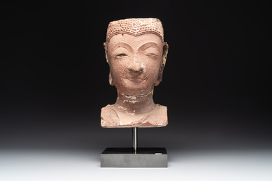 A Thai red sandstone head of Buddha, possibly Ayutthaya period, 15th C.