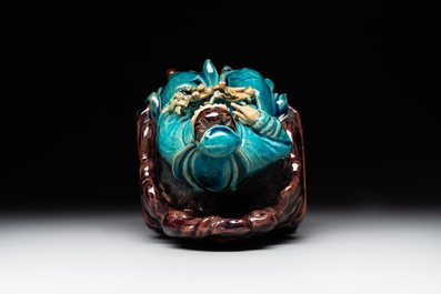 A Chinese turquoise- and aubergine-glazed sculpture of a seated scholar, 18/19th C.