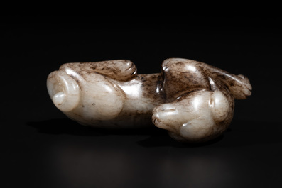 A Chinese partly black coloured white jade dog carving, Qing