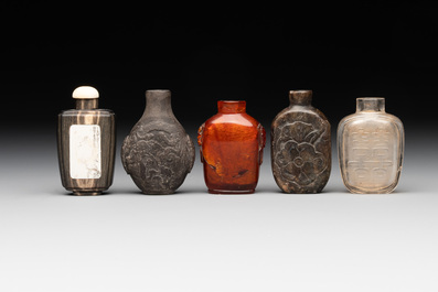 Eleven Chinese snuff bottles in amber, agate, rock crystal, lacquer, hardstone, metal and wood, 19/20th C.