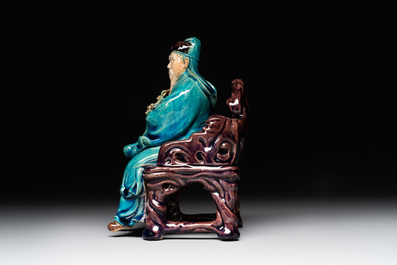 A Chinese turquoise- and aubergine-glazed sculpture of a seated scholar, 18/19th C.
