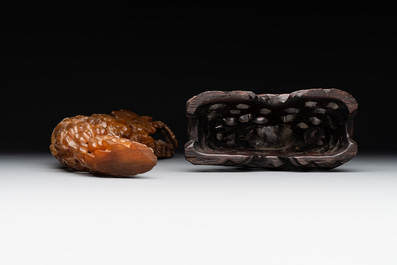 A Chinese buffalo horn carving of a landscape with a pagoda on wooden stand, Qing