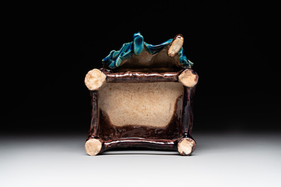 A Chinese turquoise- and aubergine-glazed sculpture of a seated scholar, 18/19th C.