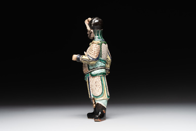 A fine Chinese verte biscuit figure of a warrior on wooden stand, Kangxi