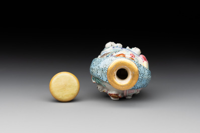 A Chinese moulded famille rose 'playing boys' snuff bottle, Qianlong mark, 19th C.