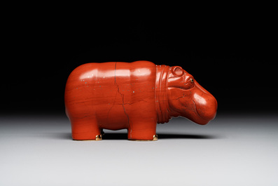 An 18kt gold mounted red jasper hippopotamus with sapphire inset eyes in Faberg&eacute;-style, early 20th C.