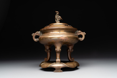 A Chinese bronze tripod censer with cover and stand, 19th C.