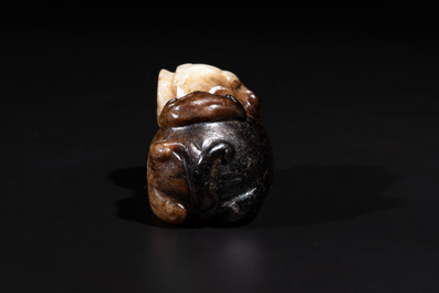 A Chinese celadon and russet jade mythical beast carving, Ming