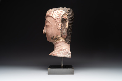 A Thai red sandstone head of Buddha, possibly Ayutthaya period, 15th C.