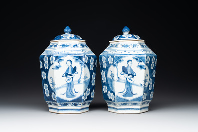 A pair of Chinese blue and white hexagonal jars and covers with a lady holding a fan, 19th C.