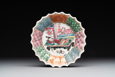 A Chinese famille rose cup and saucer with a reclined lady, Qianlong