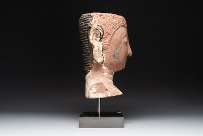 A Thai red sandstone head of Buddha, possibly Ayutthaya period, 15th C.