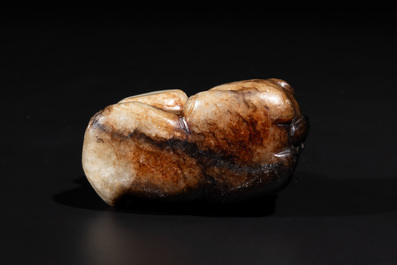 A Chinese celadon and russet jade mythical beast carving, Ming