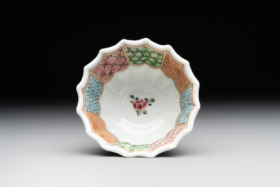 A Chinese famille rose cup and saucer with a reclined lady, Qianlong
