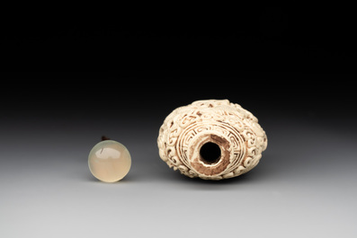 A Chinese moulded cream-glazed 'dragon and phoenix' snuff bottle, Jiaqing mark, 19th C.