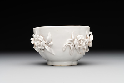 A Chinese blue and white 'butterfly' cup and saucer with applied floral design, Qianlong