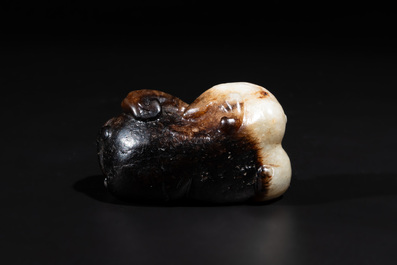 A Chinese celadon and russet jade mythical beast carving, Ming