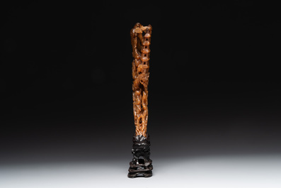 A Chinese buffalo horn carving of a landscape with a pagoda on wooden stand, Qing