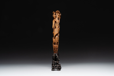 A Chinese buffalo horn carving of a landscape with a pagoda on wooden stand, Qing