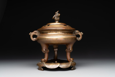 A Chinese bronze tripod censer with cover and stand, 19th C.