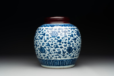 A Chinese blue and white 'flower scroll' jar with a wooden cover, Qianlong