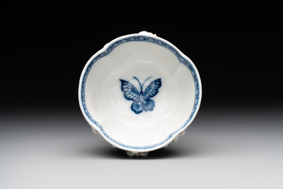 A Chinese blue and white 'butterfly' cup and saucer with applied floral design, Qianlong