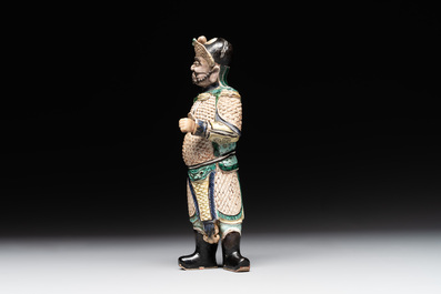 A fine Chinese verte biscuit figure of a warrior on wooden stand, Kangxi