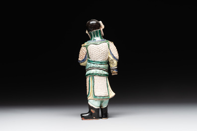 A fine Chinese verte biscuit figure of a warrior on wooden stand, Kangxi