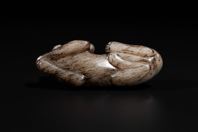 A Chinese partly black coloured white jade dog carving, Qing