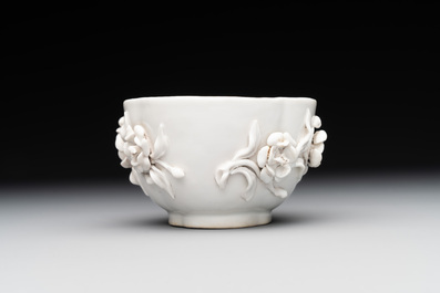 A Chinese blue and white 'butterfly' cup and saucer with applied floral design, Qianlong